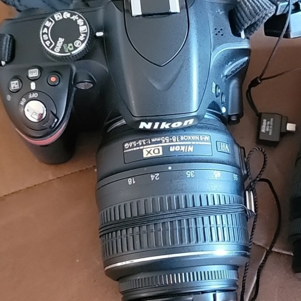 Nikon D3200 camera and 18-55 wide angle lense, and other extras